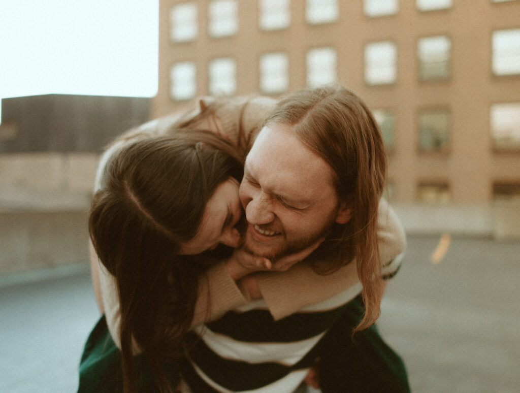 couple doing a piggy back ride and laughing